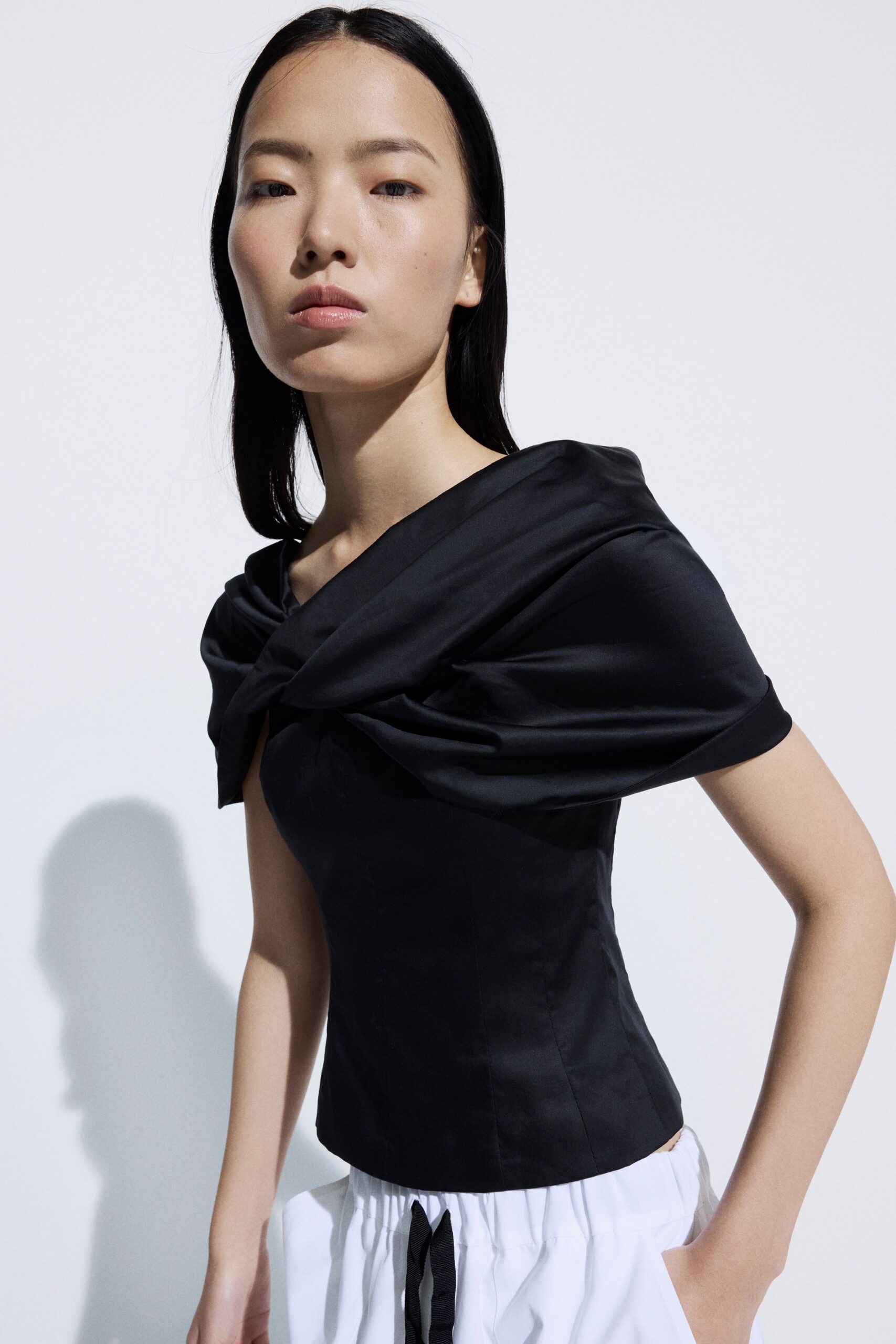 black satin asymmetric off-shoulder fitted draped shiny top