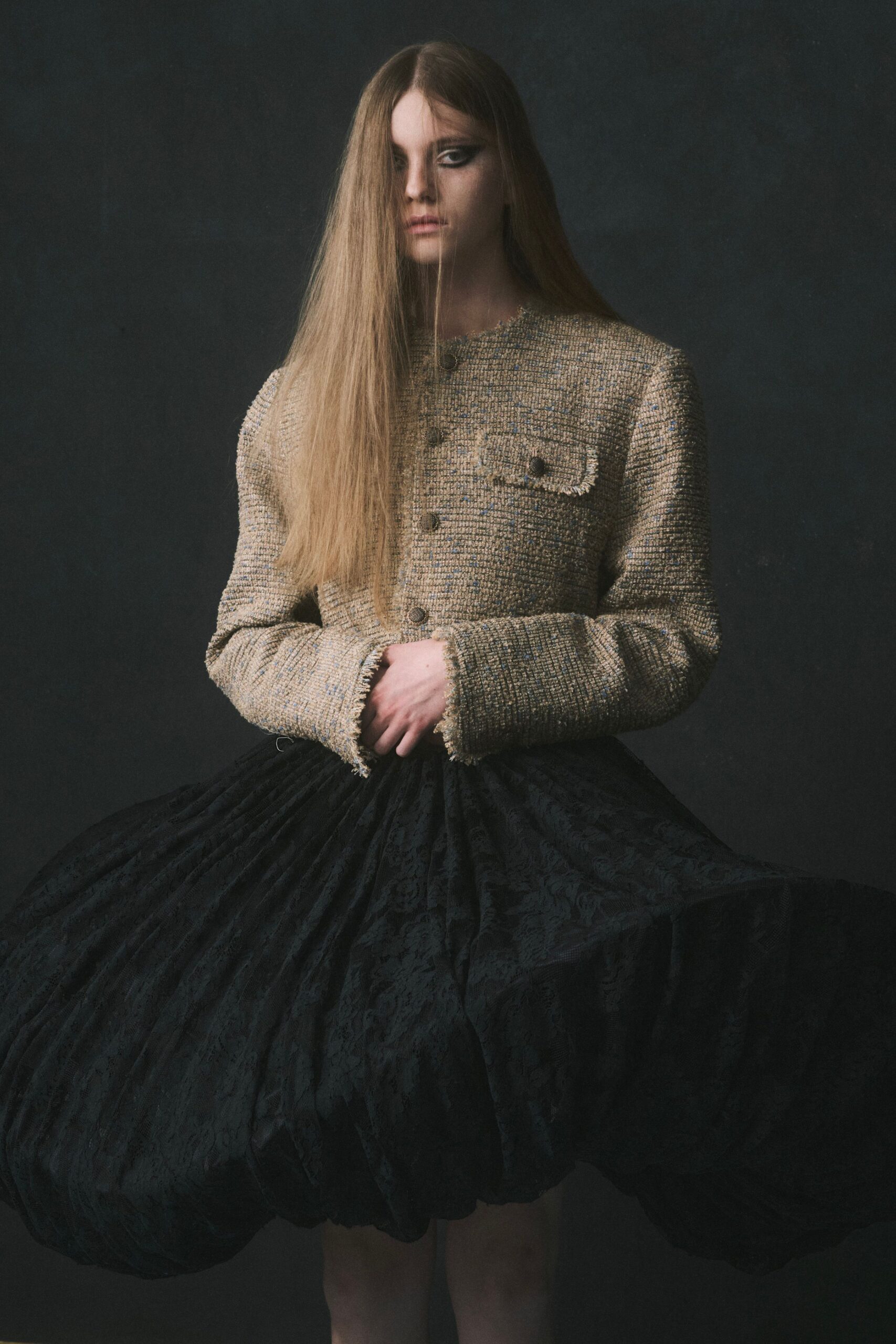 Boxy oat bouclé jacket with frayed cuffs and one flap chest pocket. Black floral jacquard bubble skirt, densely pleated into a swollen hem. Museum rotunda at closing, your footsteps louder than the guards'.
