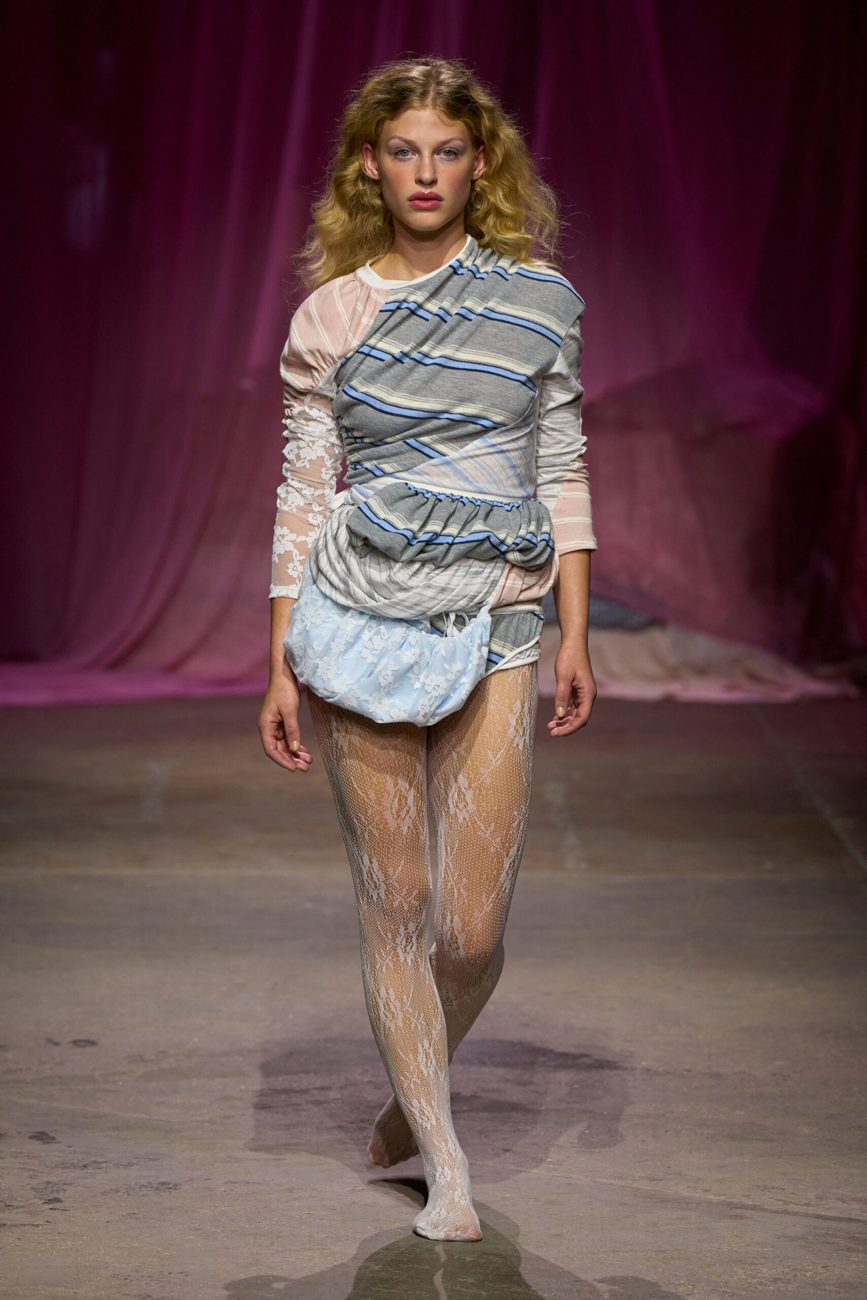 Draped patchwork dress in grey stripes, blush mesh and ruched white lace sleeves. Powder-blue lace bloomers puffing from the dropped, gathered hip. White floral lace tights, one toe peeking through the knit. For crossing a drafty seaside boarding house hallway before breakfast.