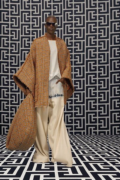 printed orange brown cape with beige pants