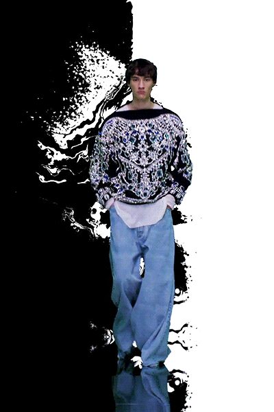 black and white embroidered sweater with relaxed denim pants