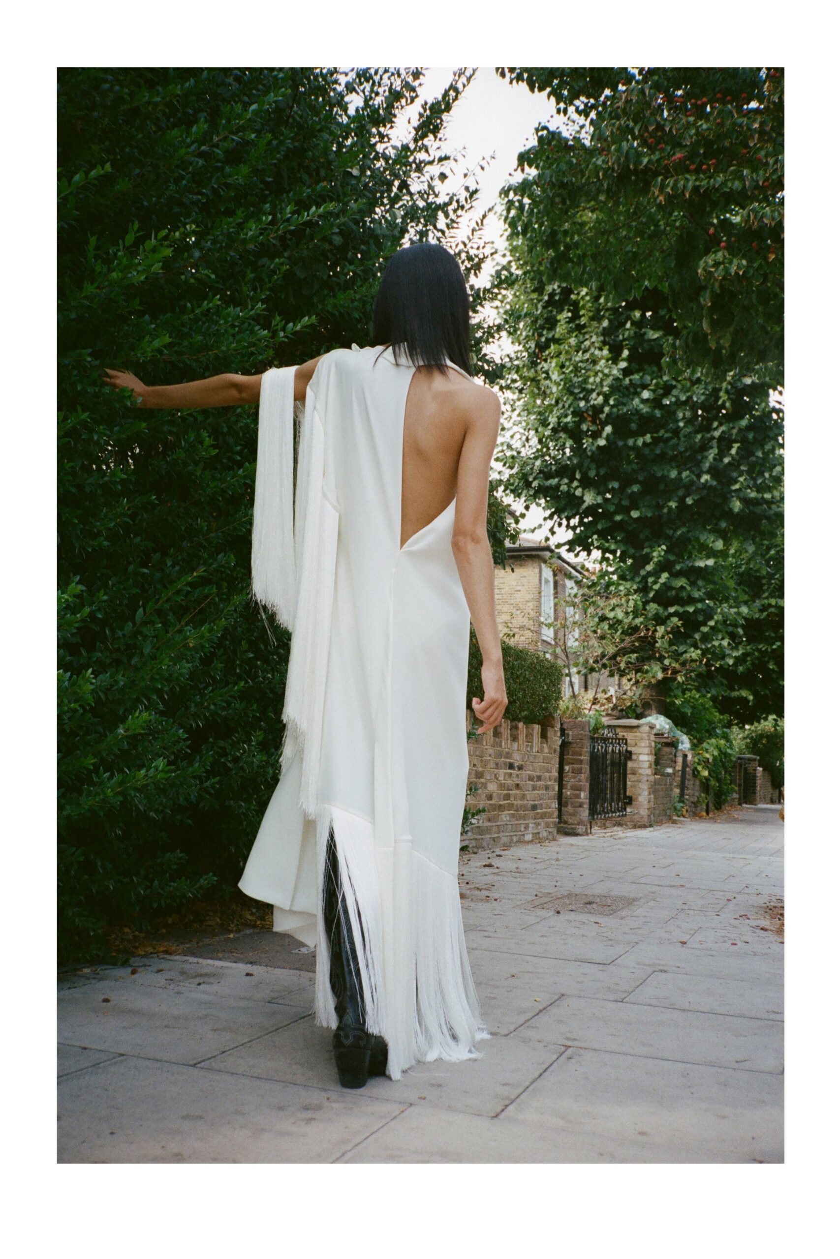 white one-shoulder fringe evening gown
