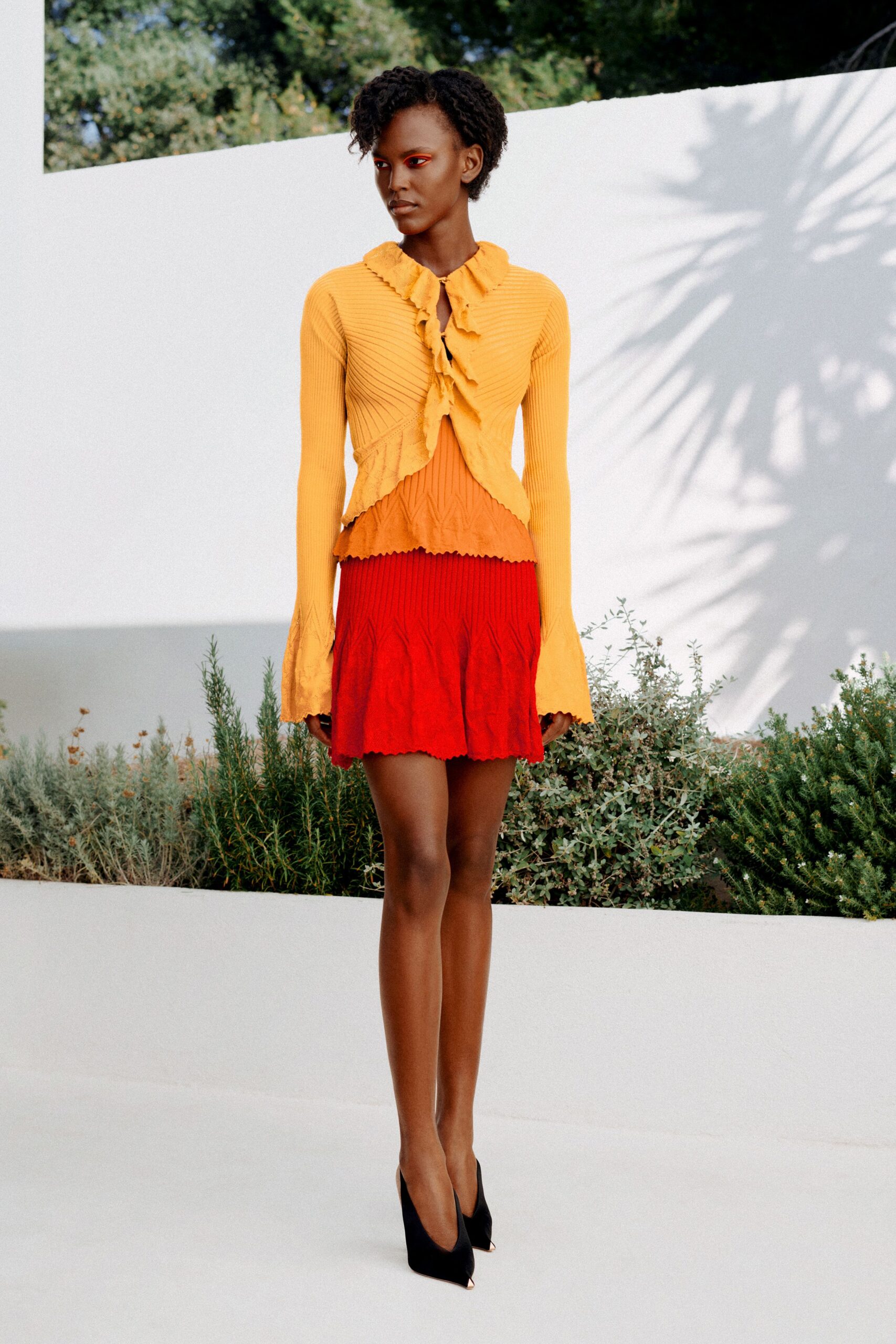 ruffled cropped cardigan over knit mini dress