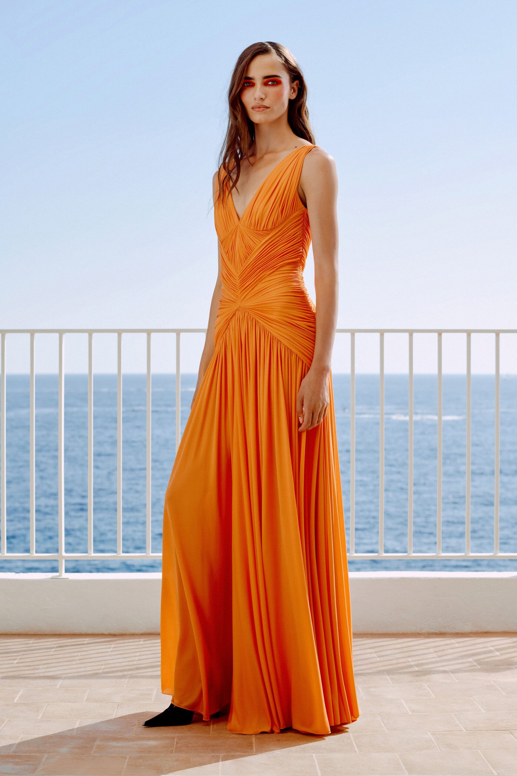 orange pleated draped evening gown
