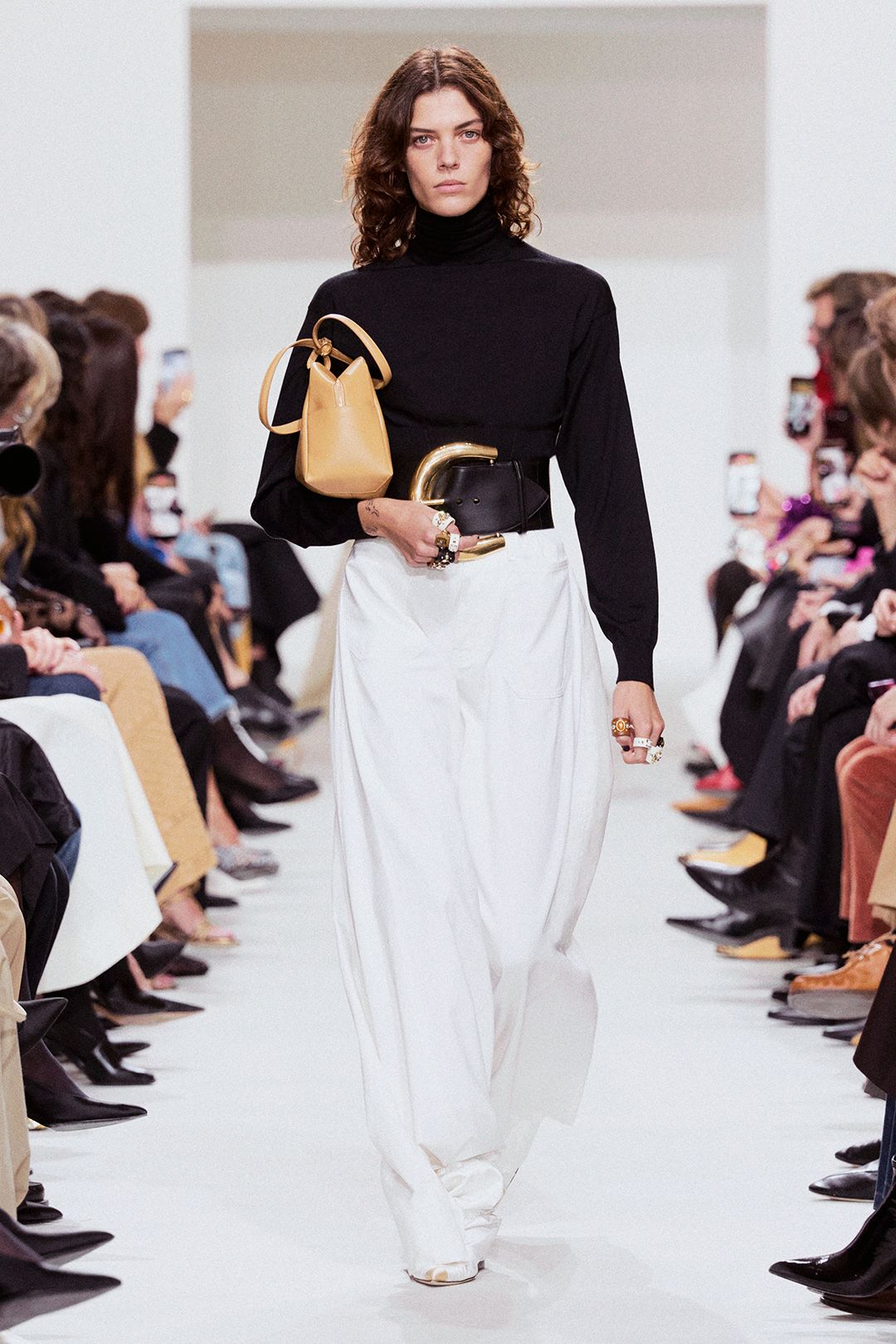 black turtleneck sweater with sculptural belt