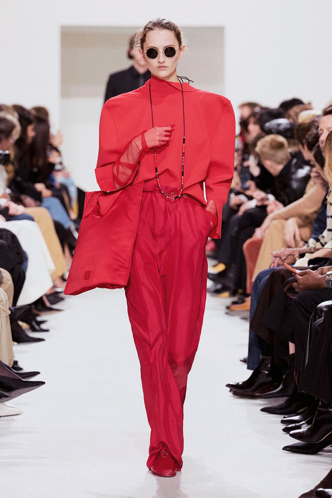 red strong-shoulder top and flowing pants