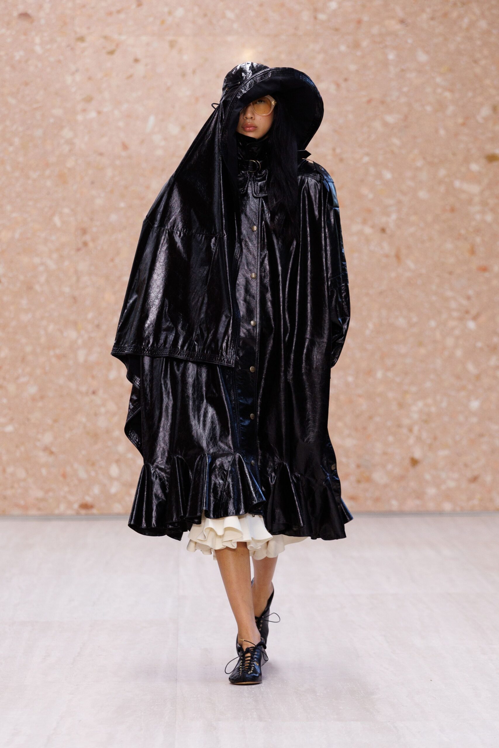 oversized black leather ruffle-hem coat