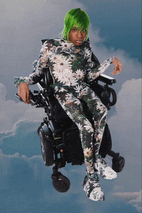Second-skin floral catsuit in glossy stretch, shoulders built into sharp pagoda points. Bulbous matching shoes, the print breaking over their padded lumps. Drifting above the city after the storm has already passed.