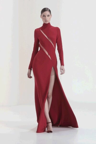 Crimson stretch-knit gown with a cutout slash from shoulder to waist. Dark red ankle-strap stilettos. Crossing a hotel lobby after midnight with one earring missing.