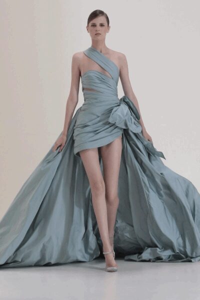 Ice-blue taffeta mini dress, cross-wrapped bodice and ruched hip bursting into a train. Pale ankle-strap heels. At the top of a hotel staircase after everyone else has gone down.
