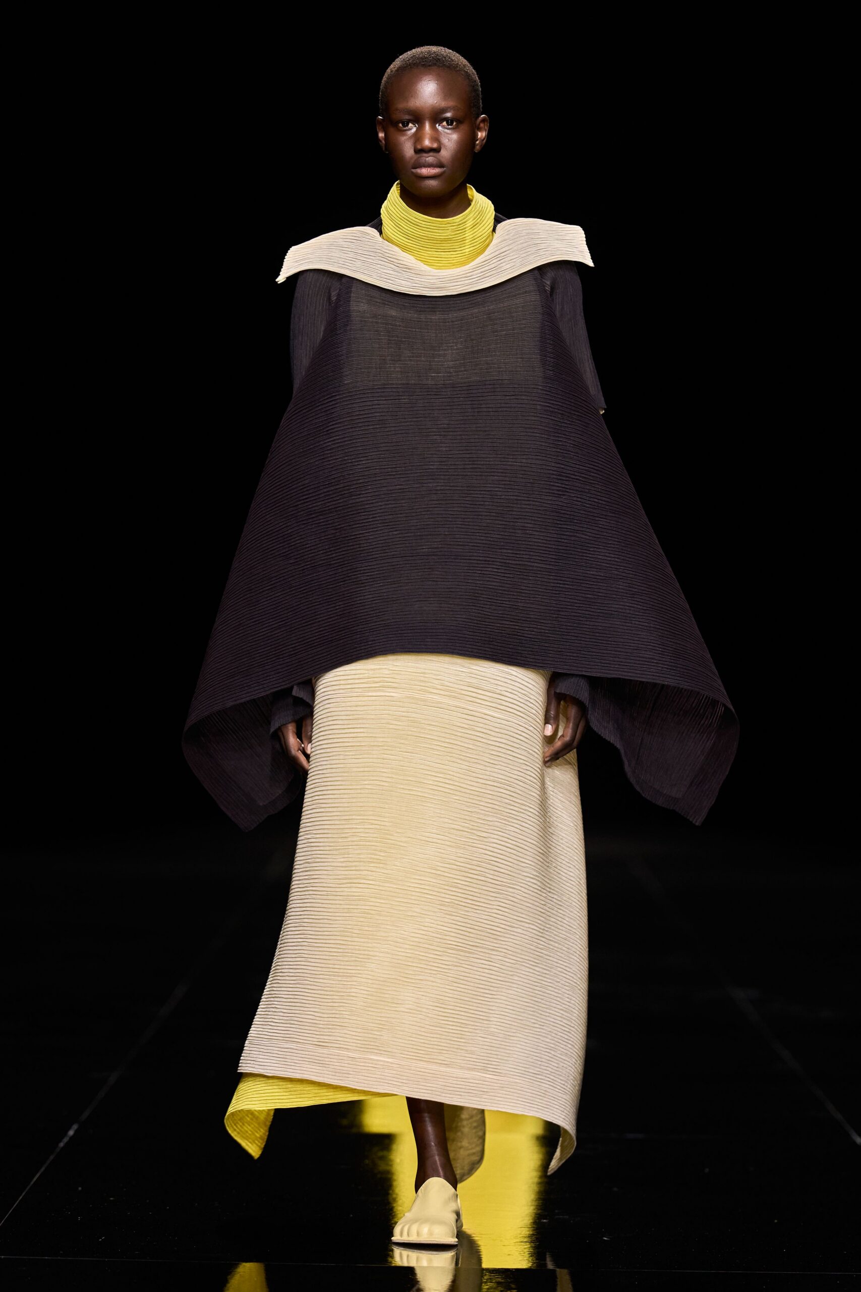 sculptural pleated poncho over column dress