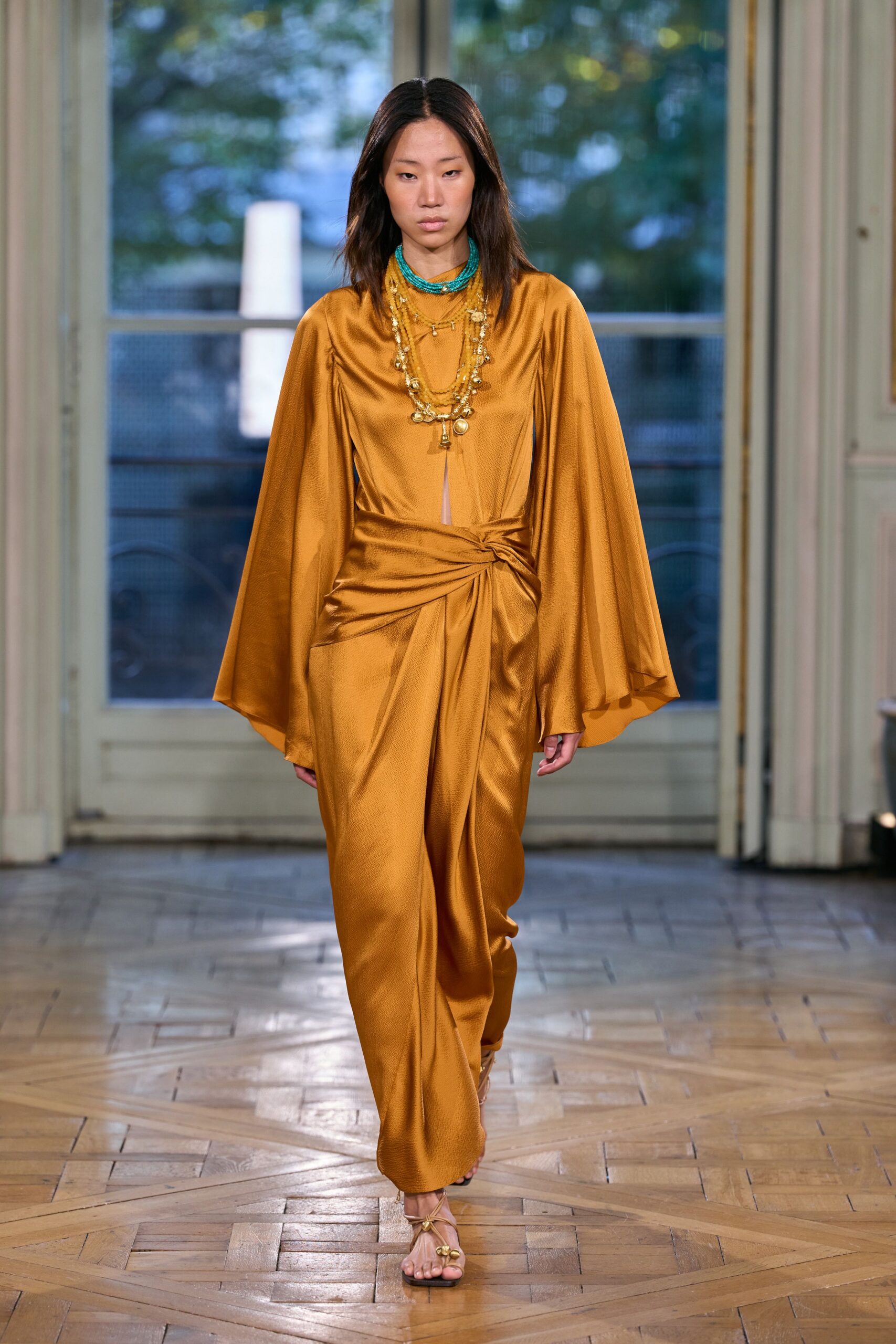 orange satin high-neck long-sleeve draped knotted gown