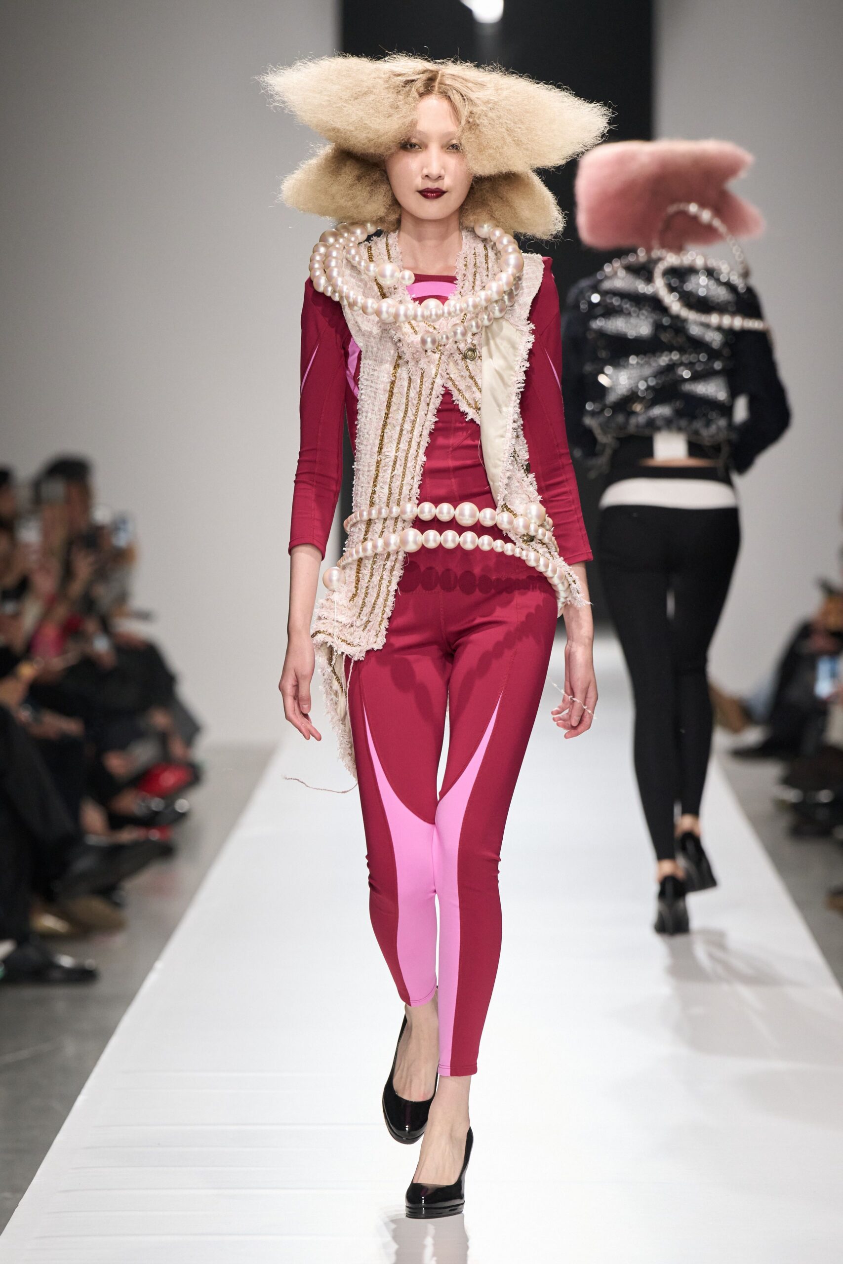 pink color-block catsuit with pearl necklace