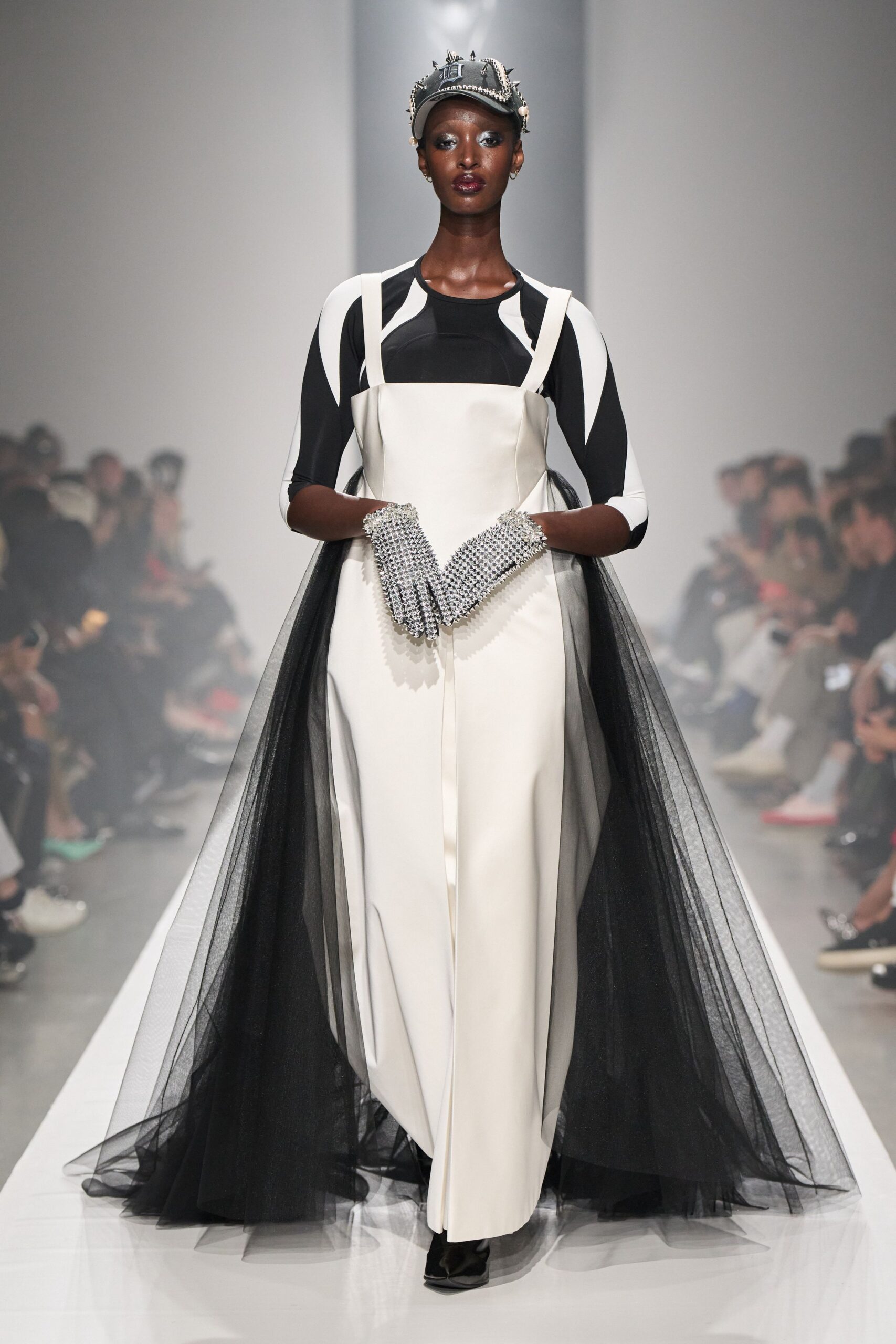 white jumpsuit with black tulle overskirt