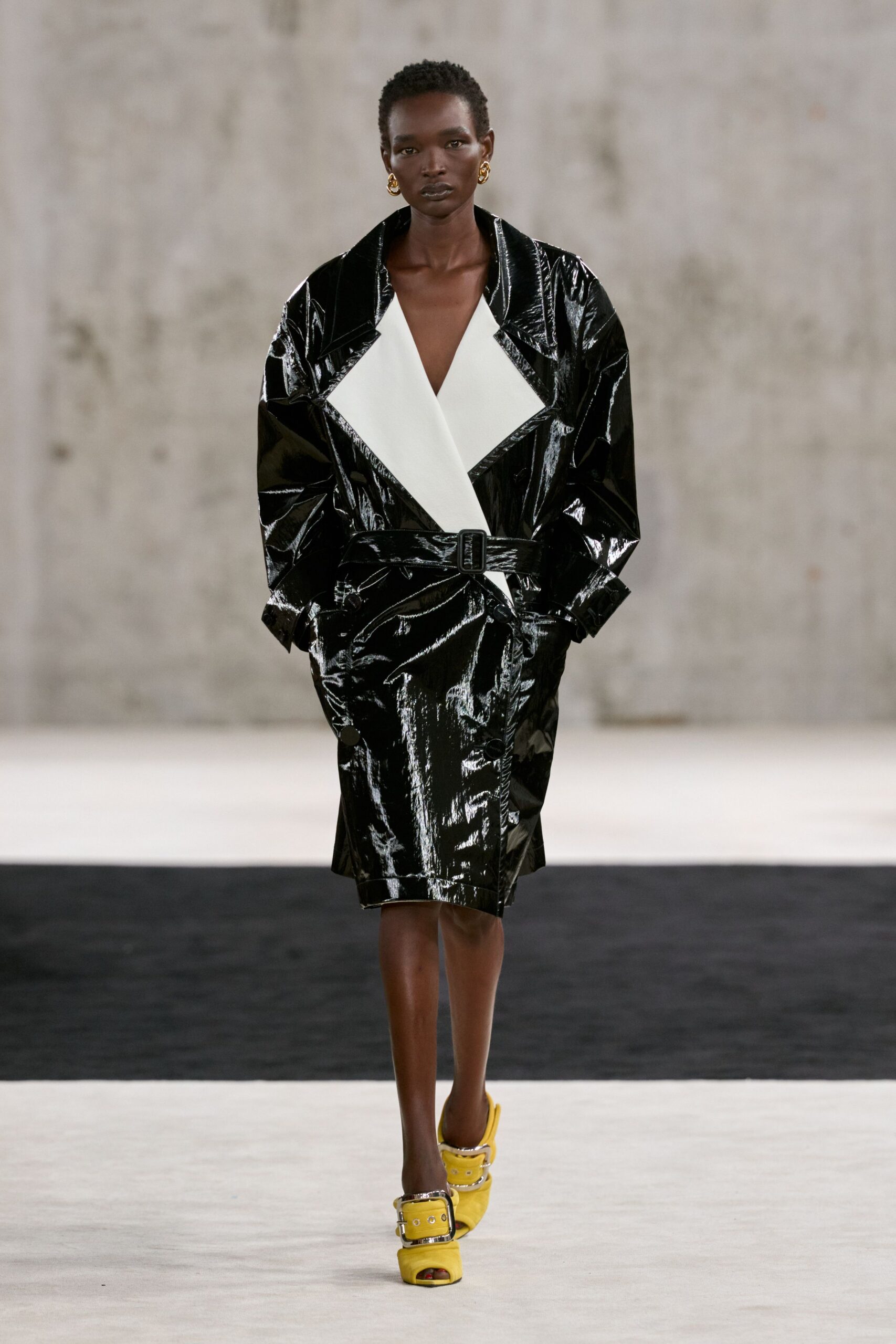 black vinyl trench coat with white lapels