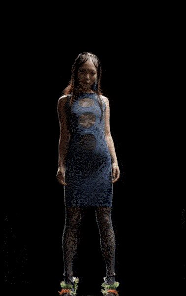 Powder-blue mesh tube dress with circular burned-out windows through the torso. Gray lace tights, dense floral pattern from thigh to ankle. Feathered mules in acid green and orange. Walking into a planetarium matinee still wearing last night's club fog.