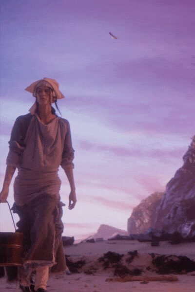 Pale headscarf tied under a stiff, angular straw brim. Dusty draped blouse with rolled sleeves and a soft cowl neck. Long gathered skirt, hitched at the sides, fringe brushing the shin. Wooden bucket swinging from one hand. Walking back up the beach before the light goes flat.