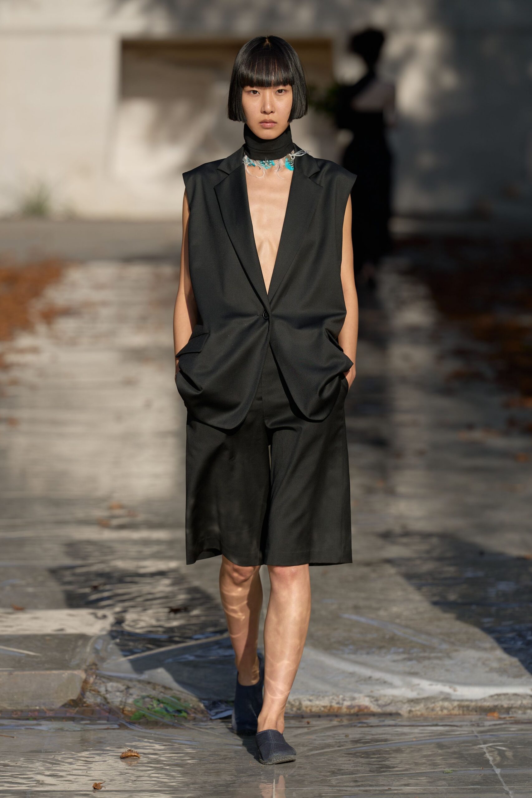 sleeveless black blazer and bermuda shorts