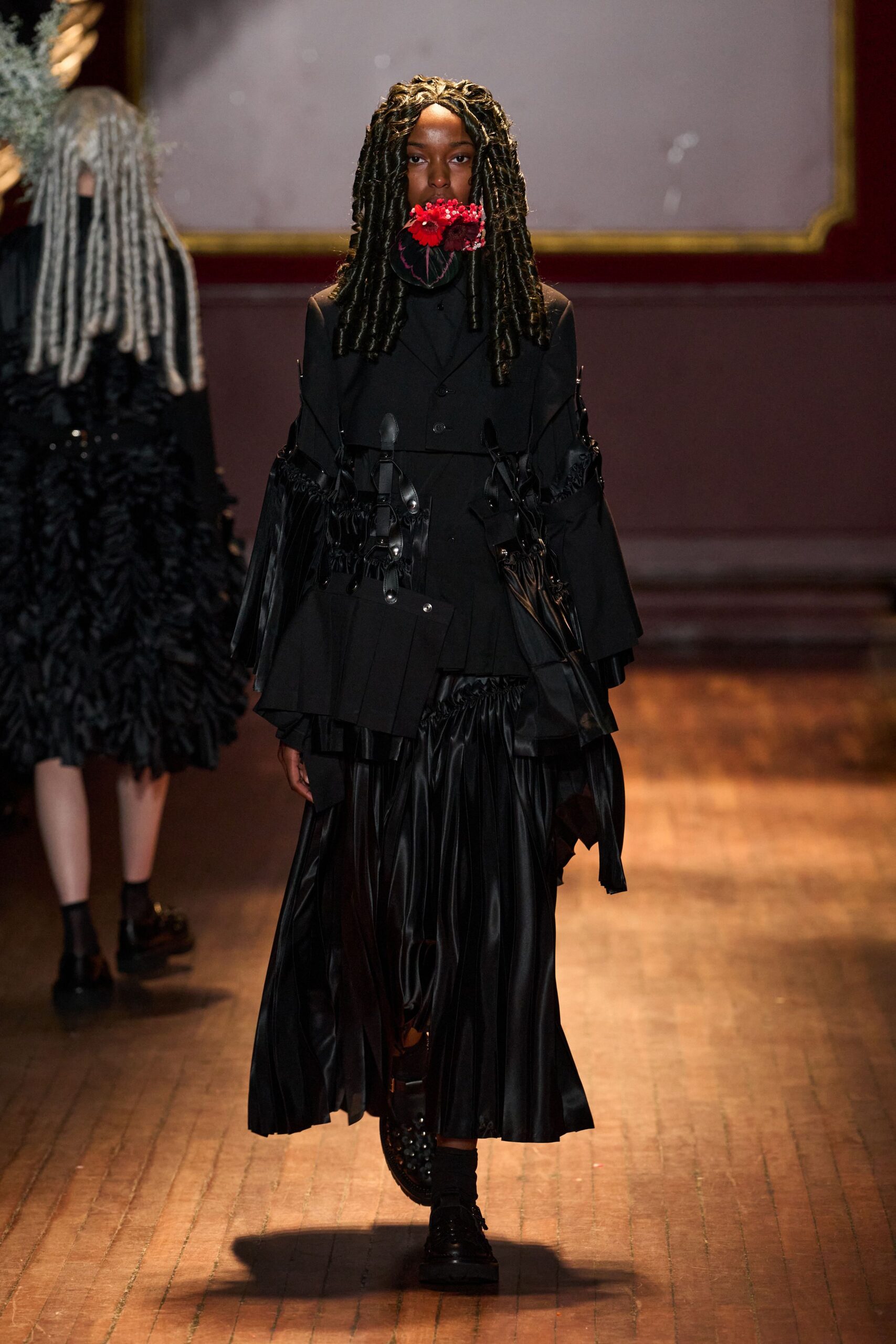 black harness jacket with pleated skirt