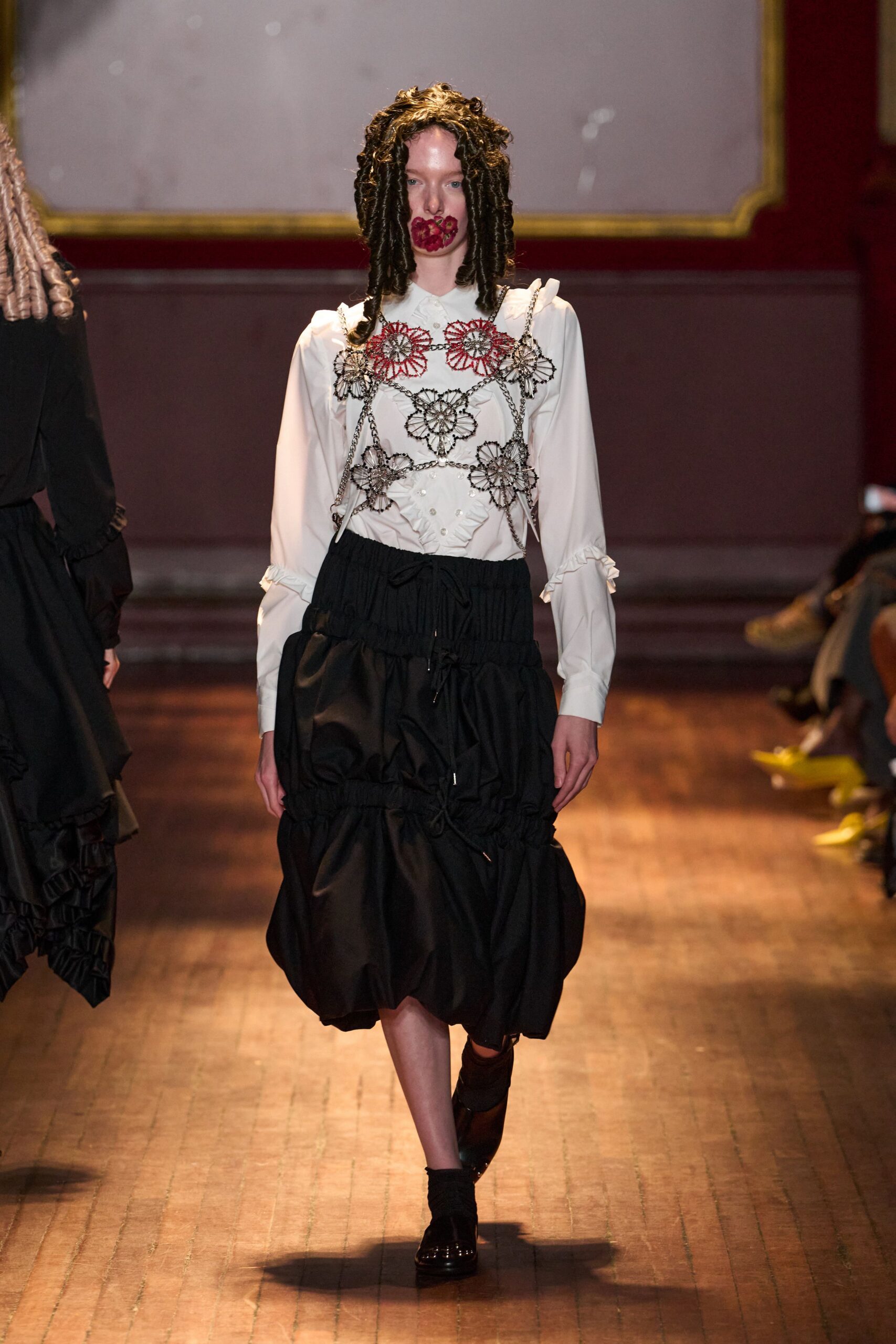 ruffled white blouse with black pinafore dress