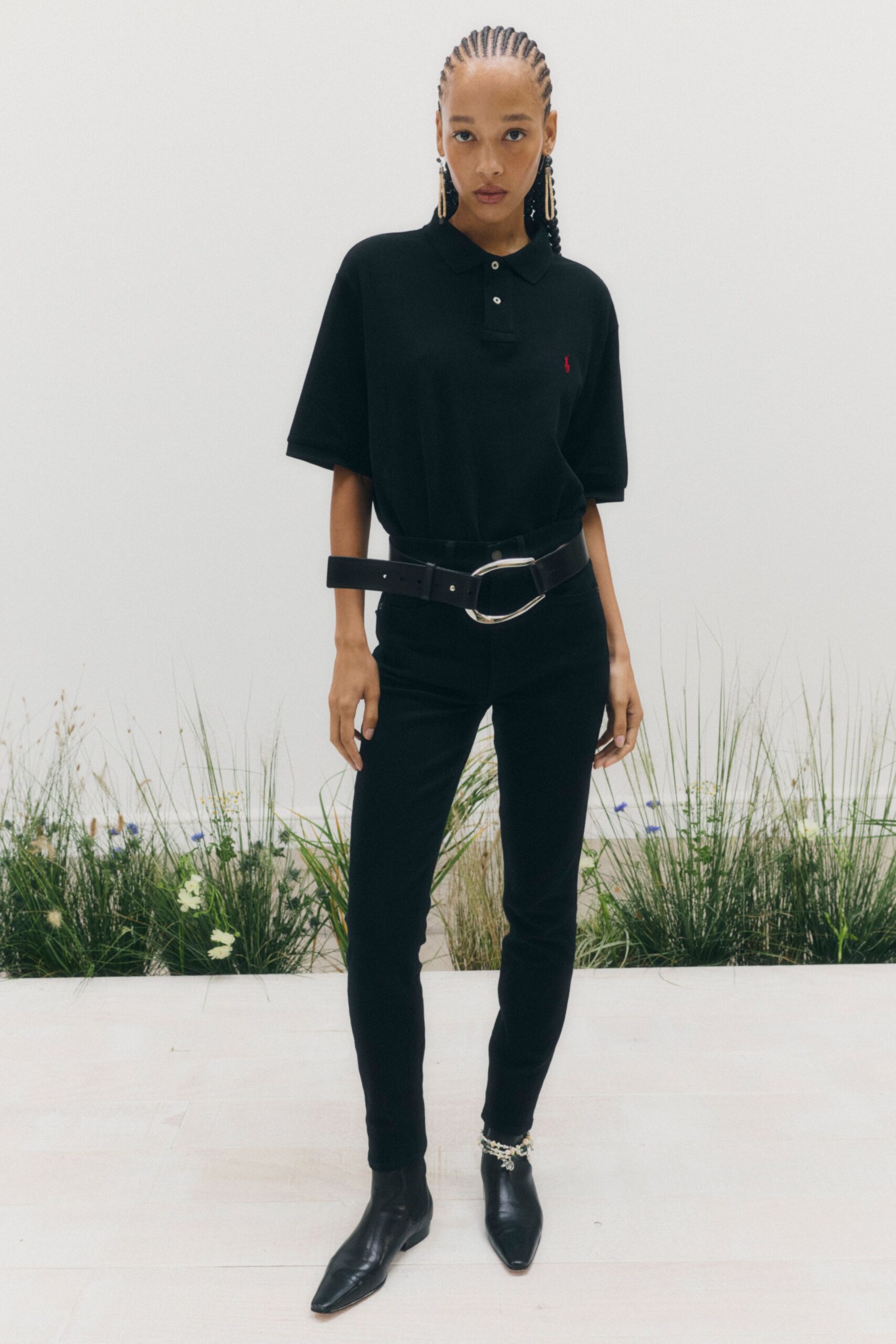 black polo shirt with oversized belt