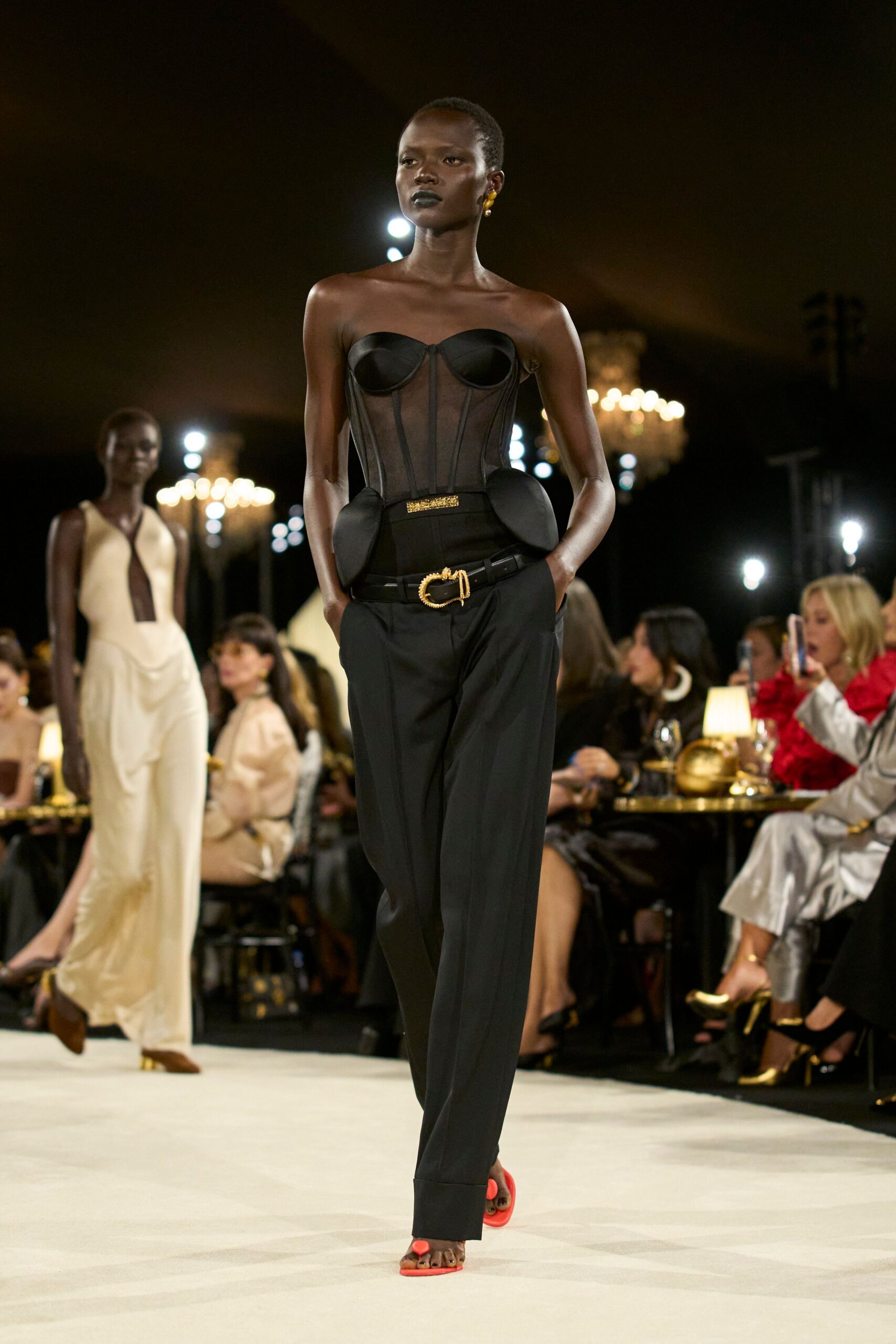 sheer corset bustier with high-waisted trousers