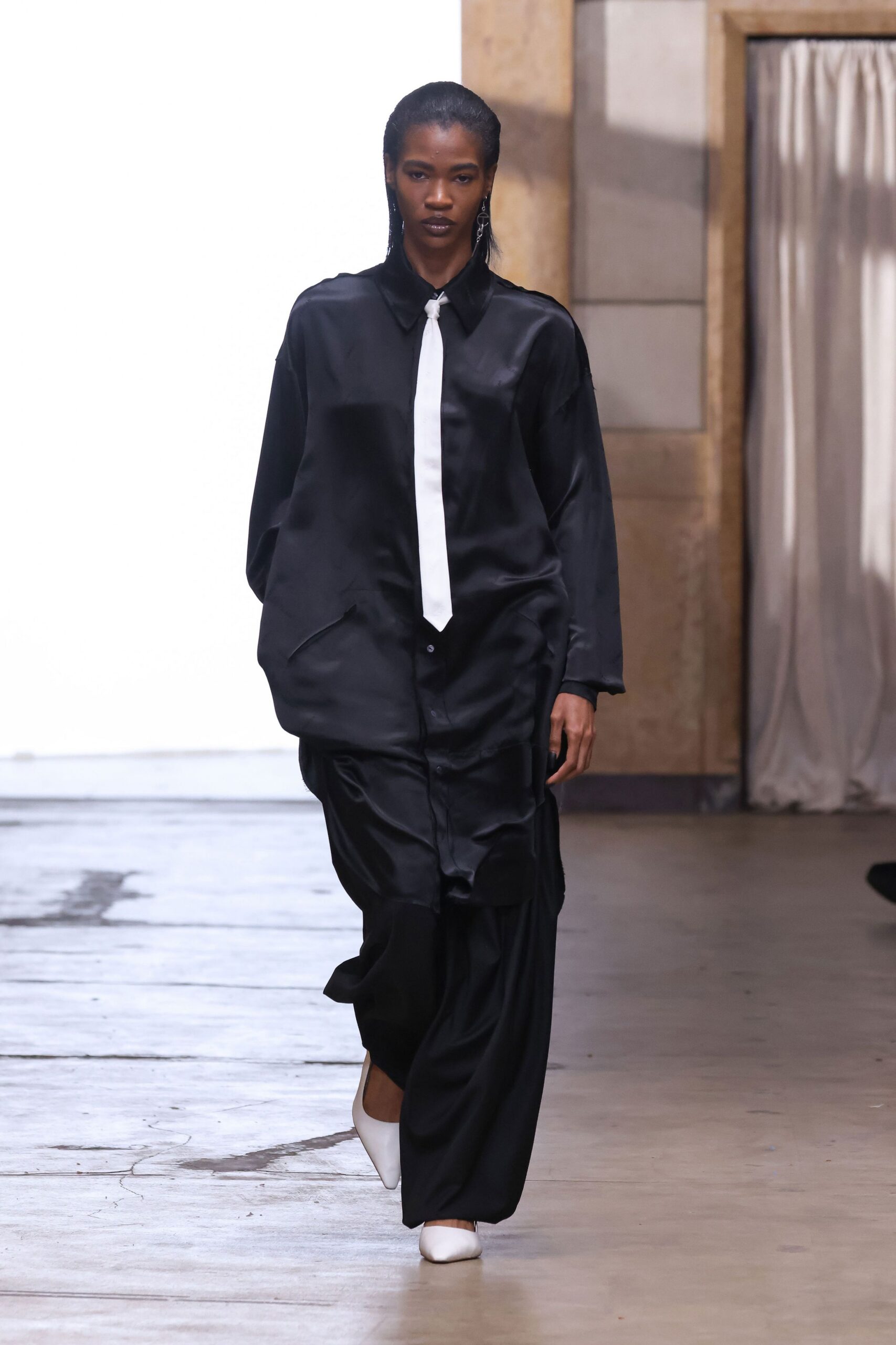 oversized black satin shirt with white tie