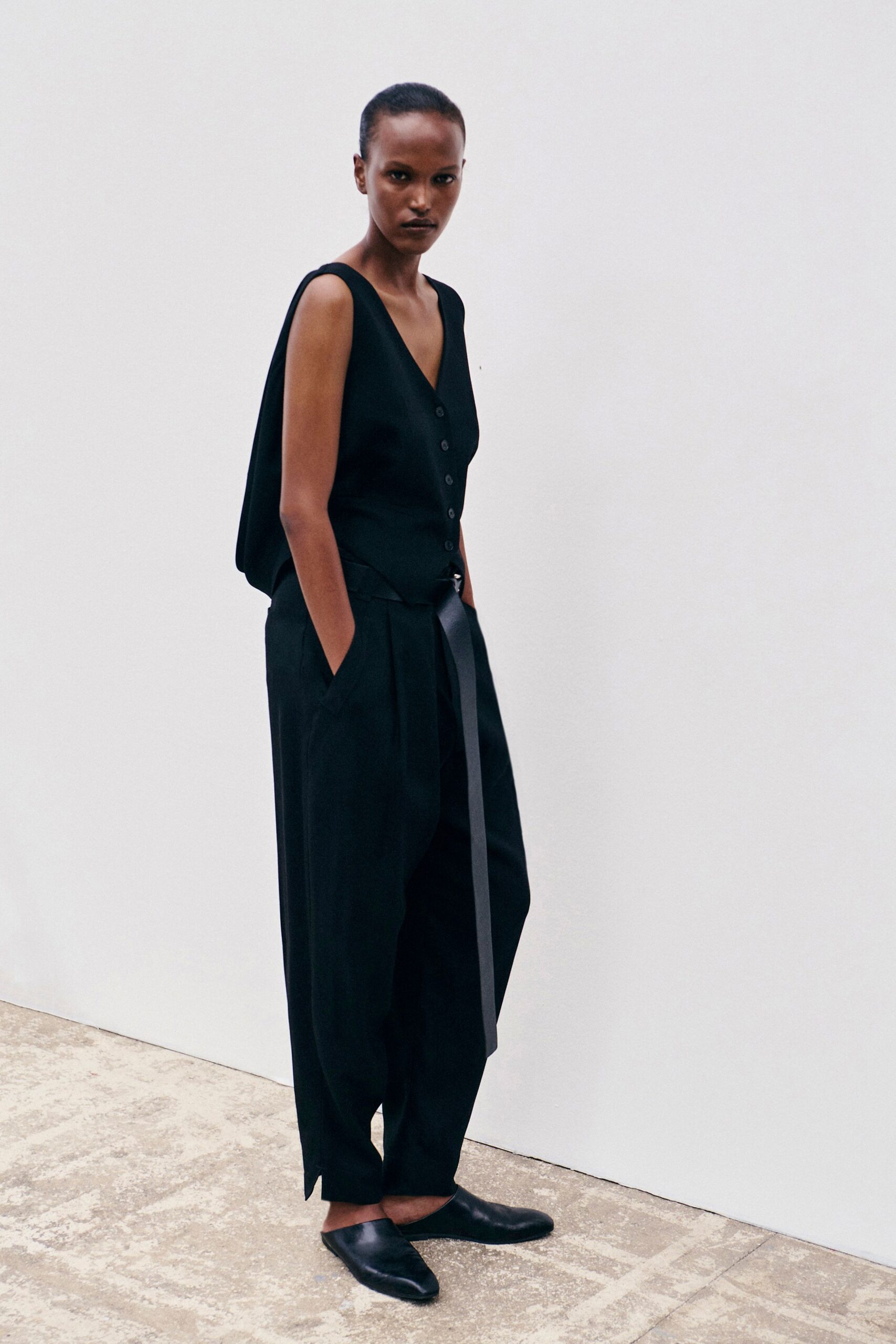 black sleeveless button-front vest