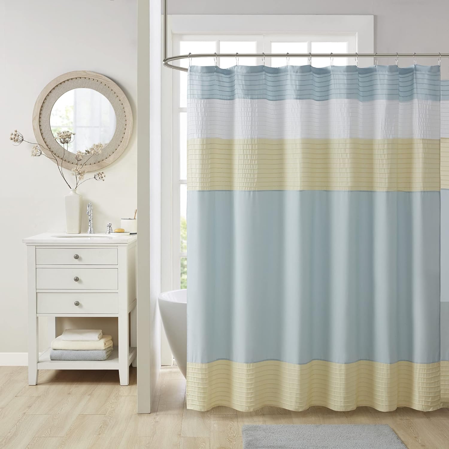 Was light and drapes nicely- see as easy to throw in washer and dryer. Pretty light colors, any of which could be used to accent your bathroom. The stitching makes it unique and adds interest. Well made, easy to hang. Vey happy with!
