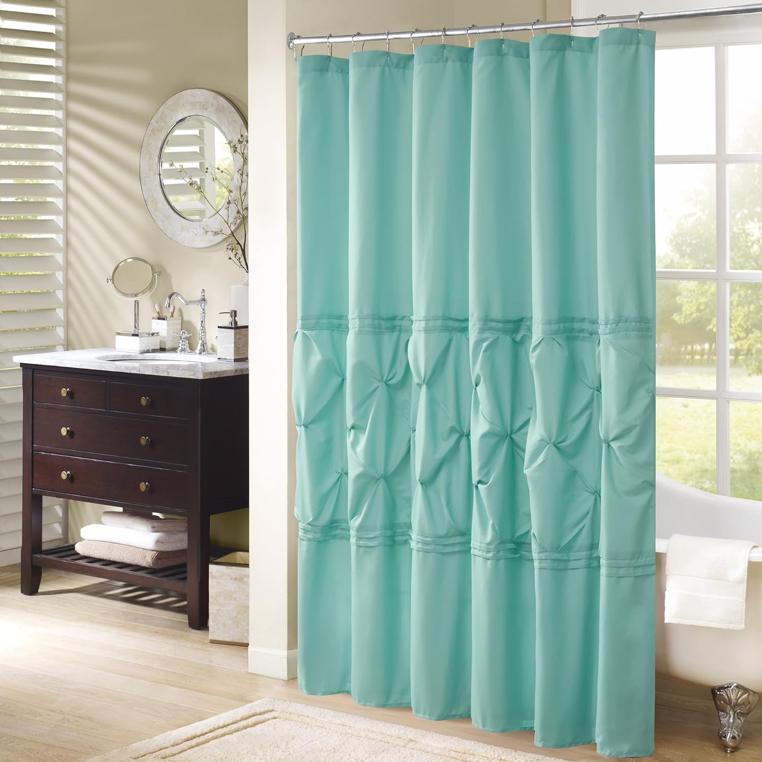 This shower curtain is beautiful. It is well made (straight stitching, no loose threads). The curtain has the navy outside fabric, which is so very soft, I can't stop touching it. It has an attached, white, thin inside liner. I am not sure if the inside liner is water proof, so I used a separate waterproof fabric shower liner. I really love the texture/design in the curtain created by the ruching and decorative folded seams. It is not transparent or sheer, only the attached liner is sheer.